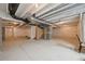 Unfinished basement with exposed ceiling and concrete flooring at 12854 Clearview St, Firestone, CO 80504