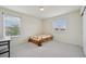 Bright bedroom featuring carpet, two windows with blinds, and a closet at 12854 Clearview St, Firestone, CO 80504