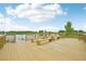 A spacious deck features lake views, wooden railings, and built in benches perfect for relaxing and entertaining at 12854 Clearview St, Firestone, CO 80504