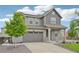Charming two-story home with a landscaped front yard, solar panels, and an attached two car garage at 12854 Clearview St, Firestone, CO 80504