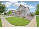 Beautifully landscaped front yard featuring lush green grass and rock landscaping for low maintenance at 12854 Clearview St, Firestone, CO 80504