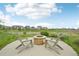 Outdoor fire pit with two Adirondack chairs overlooking a tranquil landscape at 12854 Clearview St, Firestone, CO 80504