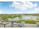 Scenic picnic area with tables, offering serene views of a tranquil lake and majestic mountains in the distance at 12854 Clearview St, Firestone, CO 80504