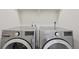 Modern laundry room featuring new LG washer and dryer units with digital displays at 12854 Clearview St, Firestone, CO 80504