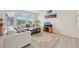 Bright living room with large windows, wood flooring, and contemporary decor at 12854 Clearview St, Firestone, CO 80504