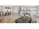 Spacious open concept living area with hardwood floors leading into the dining area and kitchen at 12854 Clearview St, Firestone, CO 80504