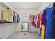 Spacious walk-in closet with organized shelving, hanging rods, and a mirror at 12854 Clearview St, Firestone, CO 80504