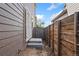 Narrow space between houses, showcasing a wooden fence and a gate at 15957 E Elk Pl, Denver, CO 80239