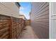 Narrow space between houses, showcasing a wooden fence and gate on both sides at 15957 E Elk Pl, Denver, CO 80239
