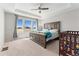 Bright bedroom boasts tray ceiling, ceiling fan, and views from the large window at 15957 E Elk Pl, Denver, CO 80239