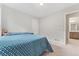 Simple bedroom with carpet, a bed with blue patterned comforter, and ample natural light at 15957 E Elk Pl, Denver, CO 80239