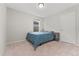 Clean and cozy bedroom with carpet, a bed with blue patterned comforter, and ample natural light at 15957 E Elk Pl, Denver, CO 80239