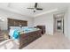 Spacious bedroom features a ceiling fan, tray ceiling, and access to other rooms at 15957 E Elk Pl, Denver, CO 80239