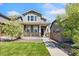 Charming two-story home featuring a welcoming front porch, landscaped lawn, and a well-maintained exterior at 15957 E Elk Pl, Denver, CO 80239
