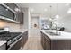 Modern kitchen featuring stainless appliances, a breakfast bar, and hardwood floors at 15957 E Elk Pl, Denver, CO 80239