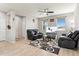 Cozy living room with plush seating, natural light, and modern ceiling fan at 15957 E Elk Pl, Denver, CO 80239