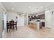 Bright open concept living space with wood floors, dining area, and modern kitchen at 15957 E Elk Pl, Denver, CO 80239