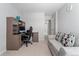 Well-lit office space with a built-in desk, couch, and a bright window at 15957 E Elk Pl, Denver, CO 80239