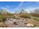 Park with rocks and logs in a sand area for at First Creek Park at Hub at Denver Connection at 15957 E Elk Pl, Denver, CO 80239