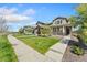 Street view of lovely homes featuring well-manicured lawns and sidewalks at 15957 E Elk Pl, Denver, CO 80239