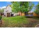 Spacious backyard with green grass, shed, trampoline, and patio furniture at 12261 N Holly Way, Brighton, CO 80602