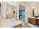 Bright bathroom with dual sinks, wood cabinets, and neutral paint at 12261 N Holly Way, Brighton, CO 80602