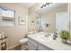 Cozy bathroom featuring neutral tones, a vanity with storage, and natural light at 12261 N Holly Way, Brighton, CO 80602