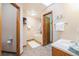 Neutral bathroom with tub, wood trim, and tile floors at 12261 N Holly Way, Brighton, CO 80602