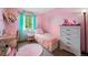 Cozy bedroom with a pink color scheme at 12261 N Holly Way, Brighton, CO 80602