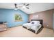 Spacious bedroom with a modern ceiling fan, natural light, and soothing blue and brown accent walls at 12261 N Holly Way, Brighton, CO 80602
