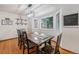 Charming dining room featuring a rustic wooden table, bay window, and stylish décor touches at 12261 N Holly Way, Brighton, CO 80602