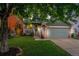Charming home featuring a well-manicured lawn, garage, and inviting front porch at 12261 N Holly Way, Brighton, CO 80602