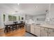 Bright, open kitchen and dining area featuring wood floors, stainless steel appliances, and modern accents at 12261 N Holly Way, Brighton, CO 80602