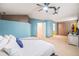 Spacious main bedroom featuring plush carpeting, a ceiling fan, and a well-organized walk-in closet at 12261 N Holly Way, Brighton, CO 80602