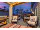 Outdoor living space featuring comfortable seating, a grill, a hot tub, and a serene backyard view at 8444 E 55Th Pl, Denver, CO 80238