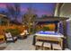 Serene backyard featuring a hot tub, fire pit, stylish seating, and lush landscaping for ultimate relaxation at 8444 E 55Th Pl, Denver, CO 80238