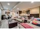 Finished basement with an exercise bike, a sectional sofa, and a bar for entertaining guests at 8444 E 55Th Pl, Denver, CO 80238
