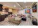 Finished basement with sectional sofa, wet bar, and Colorado sports-themed decor at 8444 E 55Th Pl, Denver, CO 80238