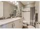 Bathroom featuring double vanity, shower, bathtub, and tile accents with decor at 8444 E 55Th Pl, Denver, CO 80238