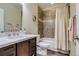 Clean, bright bathroom with tub shower combination, wood vanity, and modern fixtures at 8444 E 55Th Pl, Denver, CO 80238