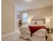 Bright bedroom featuring a bed with floral bedding and a side table with lamps at 8444 E 55Th Pl, Denver, CO 80238