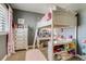 Bedroom with loft bed, workstation, closet space, and window with modern shutters at 8444 E 55Th Pl, Denver, CO 80238