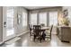 Bright dining room featuring hardwood floors, decorative curtains and three large windows at 8444 E 55Th Pl, Denver, CO 80238