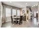 Charming dining room with a round table, three windows, and stylish window coverings at 8444 E 55Th Pl, Denver, CO 80238