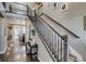 Inviting entryway features a staircase with wrought iron railing, hardwood floors, and stylish decor at 8444 E 55Th Pl, Denver, CO 80238