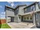 Two-story home features a gray exterior, attached carport, basketball hoop and well-maintained lawn at 8444 E 55Th Pl, Denver, CO 80238