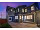 Rear exterior view of a two-story home with an attached carport and basketball hoop on the driveway at 8444 E 55Th Pl, Denver, CO 80238