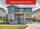 Charming two-story home with gray siding, covered porch, and well-maintained lawn at 8444 E 55Th Pl, Denver, CO 80238