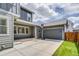 Spacious driveway leads to an attached garage, basketball hoop and a small patch of lawn at 8444 E 55Th Pl, Denver, CO 80238