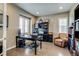 Bright home office with hardwood floors, plantation shutters, and a comfortable leather armchair at 8444 E 55Th Pl, Denver, CO 80238